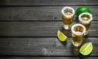 Tequila in a shot glass of salt and lime. photo