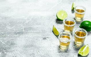 Tequila with lime wedges. photo