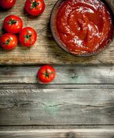 Tomato sauce in bowl on cutting Board. photo