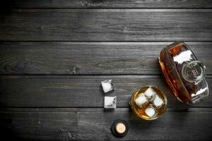 Whiskey in a glass bottle and a glass. photo