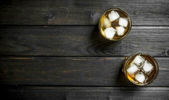 Whiskey in a glass with ice cubes. photo