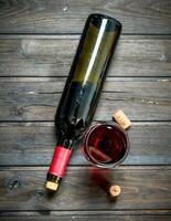 Wine background. Red wine in a bottle with a glass. photo