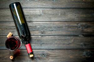 Wine background. Red wine in a bottle with a glass. photo