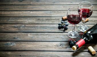 Wine background. Red wine with black grapes. photo