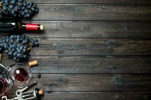 Wine background. Red wine with corkscrew. photo