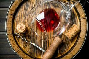 Wine background. A barrel of red wine and a corkscrew. photo