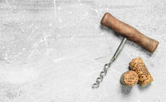 Corkscrew and corks. photo