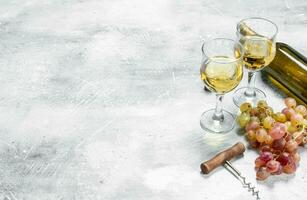 Wine background. White wine with grapes. photo