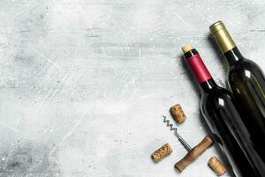 Wine background. Red wine with corkscrew. photo