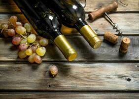 Wine background. White wine with branches of fresh grapes. photo