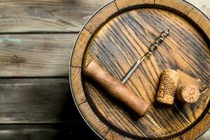 Wine background. Barrel of wine and a corkscrew from the top. photo