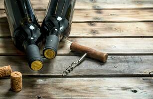 bottle of red wine with a corkscrew. photo