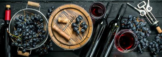 Wine background. Red wine with grapes and an old barrel. photo