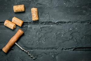 Corkscrew with corks. photo