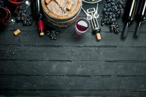 Wine background. Red wine with grapes and an old barrel. photo