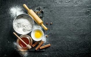 Baking background. Flour with honey, cinnamon and egg. photo