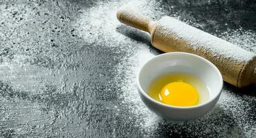 Egg with a rolling pin. photo