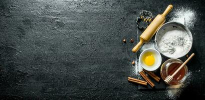 Baking background. Flour with honey, cinnamon and egg. photo