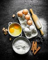 Flour with eggs, cinnamon and sugar pieces. photo