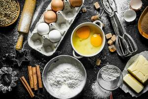 Baking background. Flour with eggs, butter and cinnamon. photo