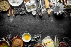 Baking background. Flour with cocoa, eggs and baking forms of the dough. photo