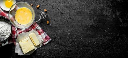 Flour with butter and egg on a napkin. photo