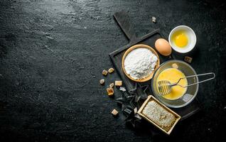 Baking background. Flour with honey and eggs on the cutting Board. photo