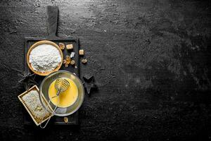 Baking background. Flour with honey and dark sugar pieces. photo