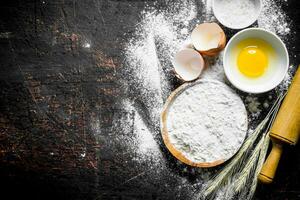 Baking background. Flour with spikeles and a rolling pin. photo