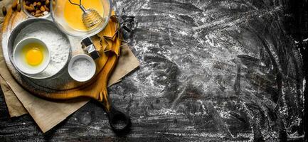 Baking background. Flour in a sieve with nuts and forms for dough. photo