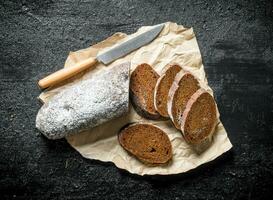 Pieces of rye bread on paper. photo