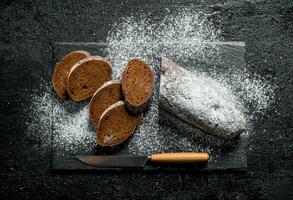 Sliced rye bread on a stone Board. photo