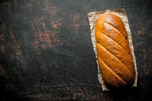 Hot fresh bread on paper. photo