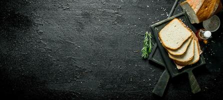 Bread with rosemary and oil on the cutting Board. photo