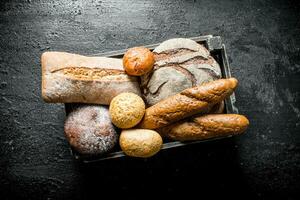 Assortment of different types of bread in the basket. photo