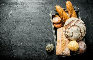 Various types of wheat and rye bread in the basket. photo