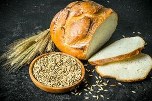 Pieces of bread with grain and spikelets. photo