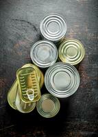 Assortment of canned food in various cans. photo