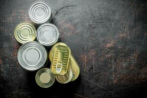 Assortment of canned food in various cans. photo