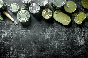 Assortment of tin cans with canned food. photo