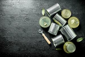 Assortment of different types of tin cans with canned food. photo