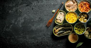 Set of different open tin cans with canned food. photo