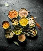 Set of different open tin cans with canned food. photo