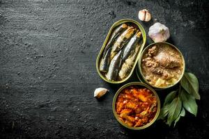 Open tin cans with canned fish and meat. photo