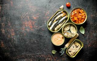 Assortment of canned food in open aluminum cans. photo