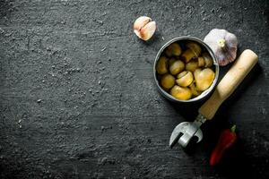 Open tin can with canned mushrooms. photo