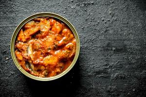 Sprat in tomato sauce in a tin can. photo