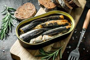 Sprats with rosemary and sliced bread. photo