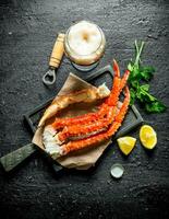 Crab with beer, parsley and lemon slices. photo