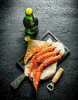 Boiled crab on paper with a bottle of beer. photo